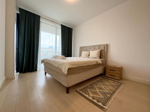 a bedroom with a bed and a large window at Magnolia Apartment Luxury and Relaxation on the Sava in Belgrade