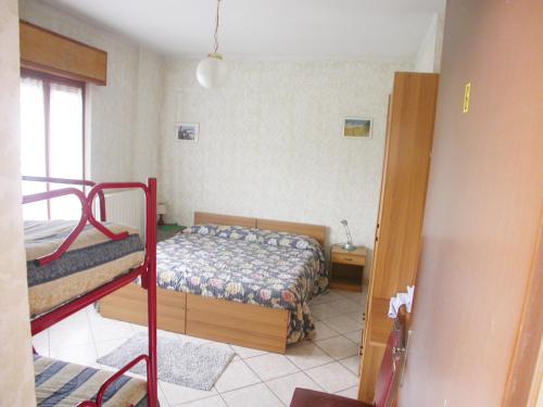 a bedroom with two bunk beds and a window at Agriturismo La Bordiga in Paesana