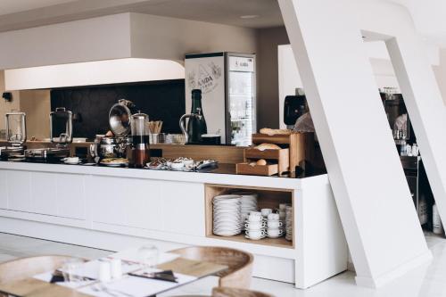 a kitchen with a counter with dishes on it at Zorbas Lifestyle Hotel in Georgioupolis