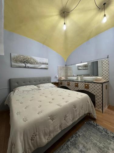 a bedroom with a bed and a bathroom with a mirror at Casa Ponte Raddi in Colli al Volturno