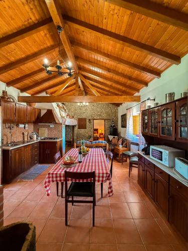 a kitchen with a table with a red and white table cloth at Monte dos Touris in Santiago do Cacém