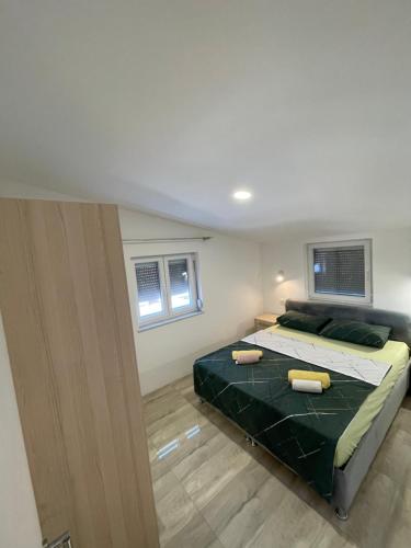a bedroom with a bed with two pillows on it at Vila White Pearl in Vir