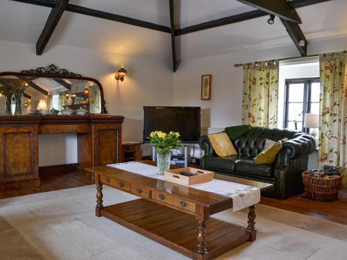 a living room with a couch and a coffee table at The Old Granary in Kilkhampton