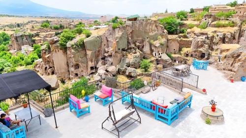 a view from the top of a resort with chairs and tables at Kapadokya Ihlara Konaklari & Caves in Guzelyurt