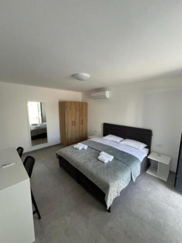 a bedroom with a bed with two towels on it at Guesthouse Dreamscape city Krk in Krk