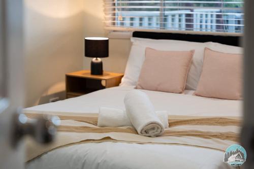 a bedroom with a bed with towels on it at Spacious 4BR House Near Kingswood & Penrith CBD in Kingswood