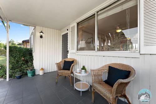 a patio with two chairs and a table on a porch at Spacious 4BR House Near Kingswood & Penrith CBD in Kingswood