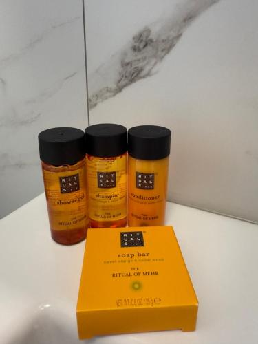 two bottles of honey next to a yellow box at Diamond Deluxe Loft in Iraklitsa
