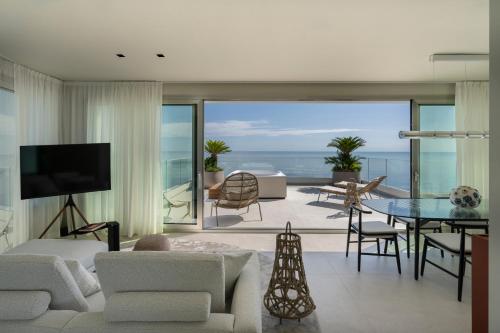 a living room with a view of the ocean at Opera Suite Hotel Pesaro in Pesaro