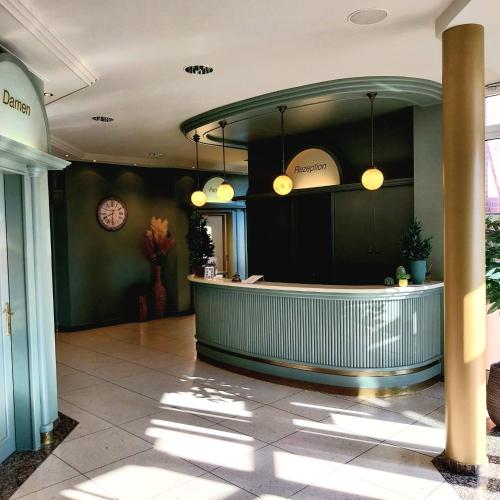 a lobby with a counter in a building at Auehof Hotel & Restaurant in Garrel