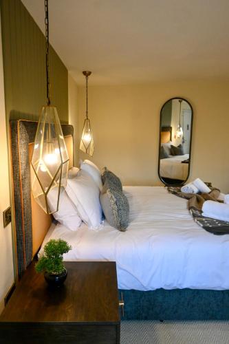 a bedroom with a large bed with a mirror at The Apple Inn in Lucker