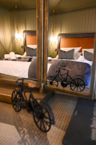 a reflection of a bike in a bedroom with two beds at The Apple Inn in Lucker