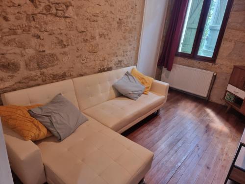 a living room with a white couch with two pillows at Pechaud 2 in Lalinde