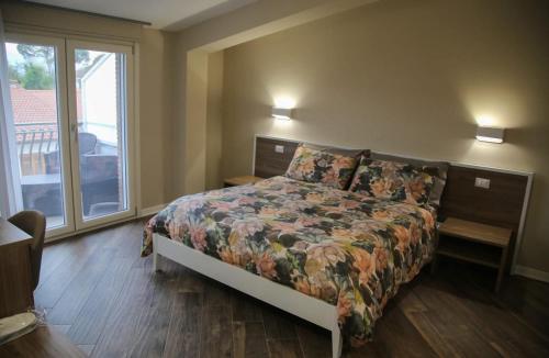 a bedroom with a bed and a large window at B&B Martina in Mirabella Eclano