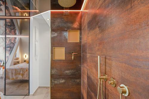 a bathroom with a shower with a glass door at AmbassadOr Elegance and comfort steps from the naturist beach in Cap d'Agde