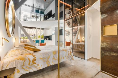 a bedroom with a large bed and a staircase at AmbassadOr Elegance and comfort steps from the naturist beach in Cap d'Agde