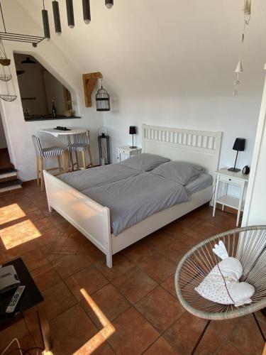 a bedroom with a bed and a table and chairs at Ferienweingut Schlägel in Bremm