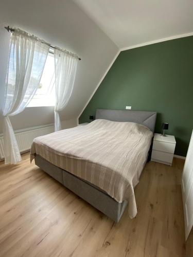 a bedroom with a large bed and a window at Gemütliche Wohnung in Xanten
