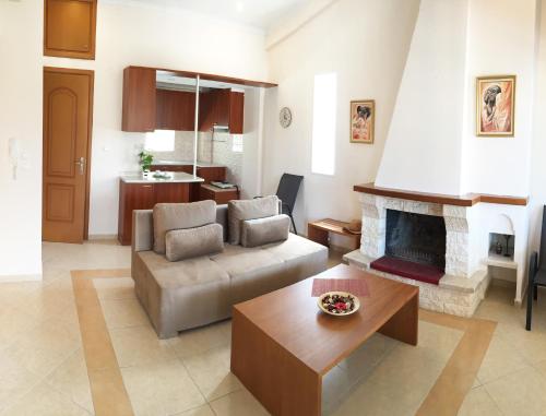 a living room with a couch and a fireplace at Villa Verano in Asprovalta