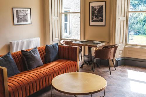 a living room with a couch and a table at The Victorian Suite in Marske
