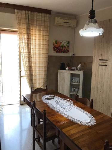 a dining room table with a white plate on it at Residenza delle Rose in Lamezia Terme