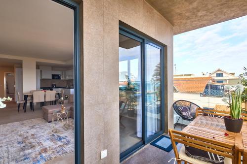 a view of a living room with sliding glass doors at Apartamentos Golfinho Dourado in Santa Maria