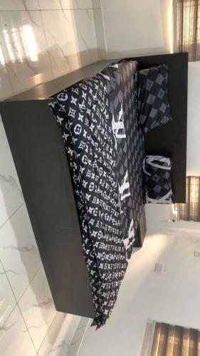 a black and white tie hanging on a wall at 4 bedroom apartment in Igaun