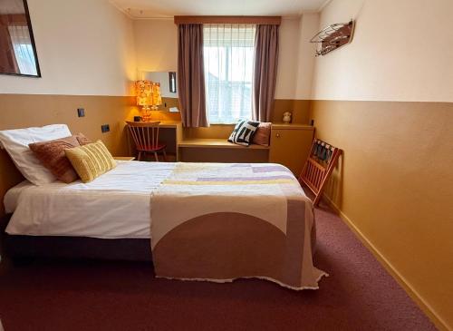 Postel nebo postele na pokoji v ubytování Hotel Restaurant Ruimzicht