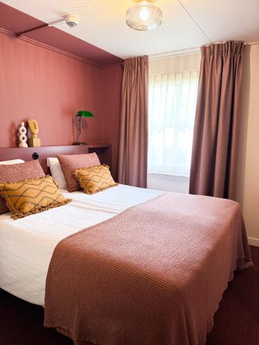 Postel nebo postele na pokoji v ubytování Hotel Restaurant Ruimzicht