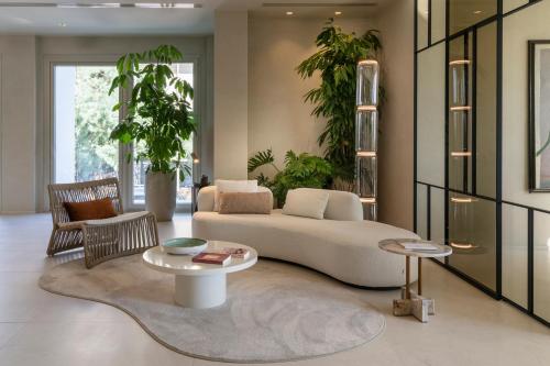 a living room with a couch and a table at Opera Suite Hotel Pesaro in Pesaro