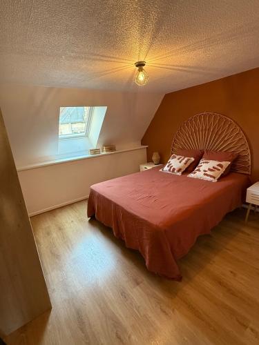 a bedroom with a large bed and a window at Le Nid Dolois in Dole