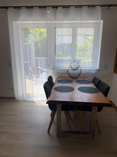 a dining room table with chairs and a large window at Luxus Urlaub auf 1000 Meter im Erholungsparadies in Liebenau