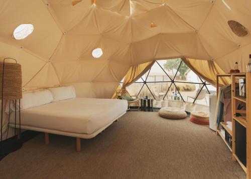 a bedroom with a bed in a tent at wecamp Cabo de Gata in Las Negras