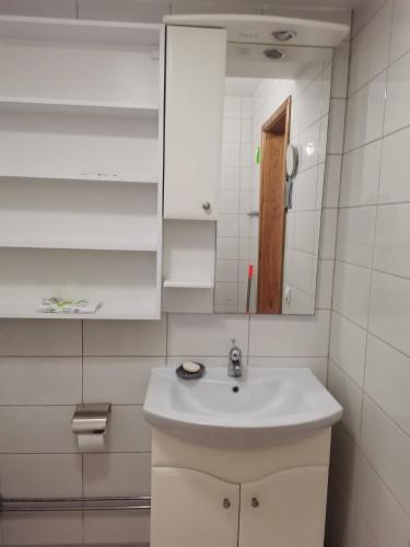 a bathroom with a white sink and a mirror at The White House in Kavadarci