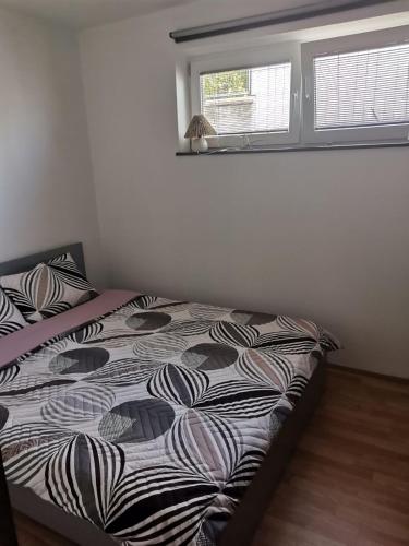a bed in a bedroom with a window at The White House in Kavadarci