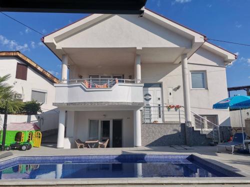 a house with a swimming pool in front of it at The White House in Kavadarci