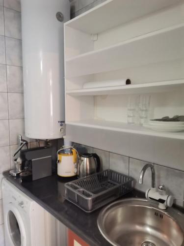 a kitchen counter top with a sink and a sink at The White House in Kavadarci