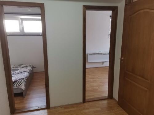 a bedroom with a bed and a mirror in a room at The White House in Kavadarci