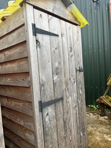 a wooden door on the side of a fence at Black Bridge Cabin in Lyonshall