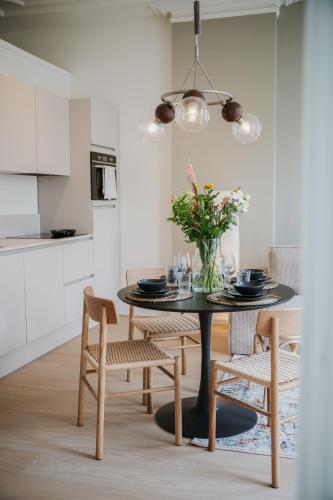 a dining room with a black table and chairs at Naest - Authentic Escapes City House Nijmegen in Nijmegen