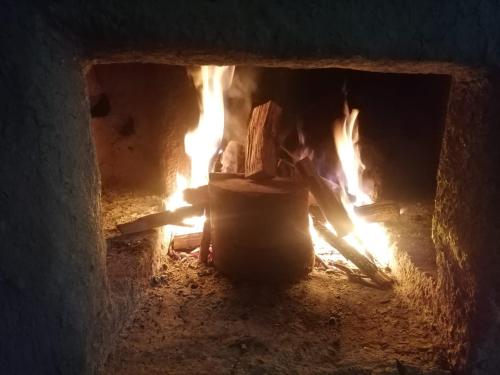 a brick oven with a fire in it at Jungle Lodge Quillabamba All included 