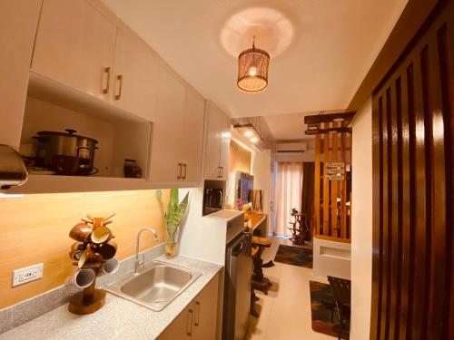 a kitchen with a sink and a counter top at Cool Suites at SMDC Wind Residence Tagaytay in Tagaytay
