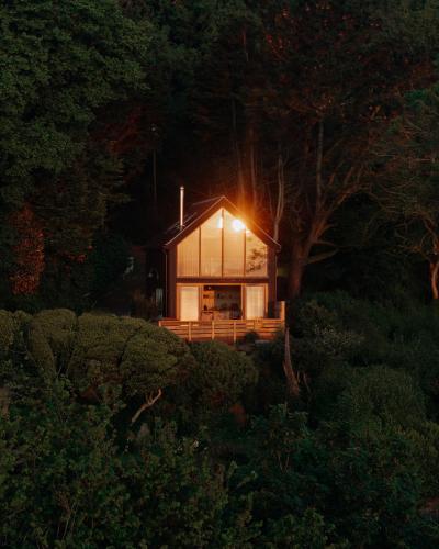 a house with a light on the front of it at 1-bed luxury seafront cabin in heart of Newlyn, Mousehole in Newlyn