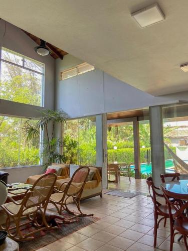 a living room with a couch and tables and chairs at Sossego Homestay - Chapada dos Guimarães in Chapada dos Guimarães