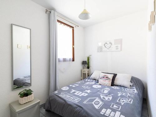 une chambre avec un lit et un miroir dans l'établissement Appartement T2 avec jardinet, parking et casier à skis, quartier thermal, proche télécabine, 2 étoiles - FR-1-296-171, à Saint-Lary-Soulan