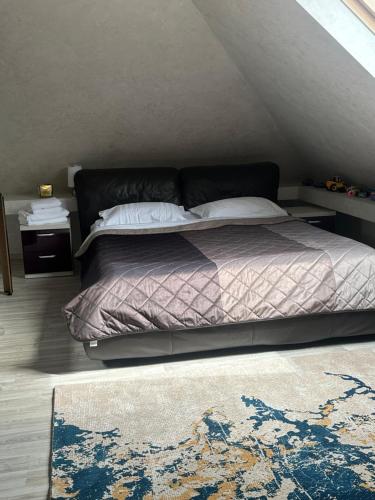 a bedroom with a bed and a rug at Casa Adi Sucevița in Voivodeasa