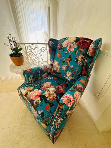 a blue chair with flowers on it in a room at La Presentosa b&b in Fossacesia