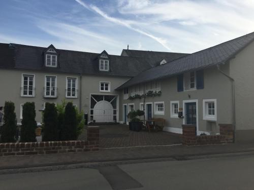 a large white house with a patio in front of it at Ferienwohnung Stübchen in Salmtal