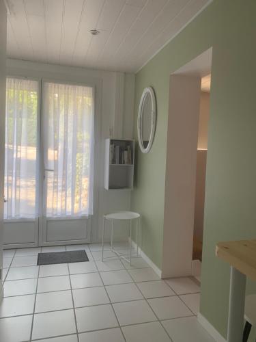 a white room with a table and a window at Un petit coin de Paradis in Lalley