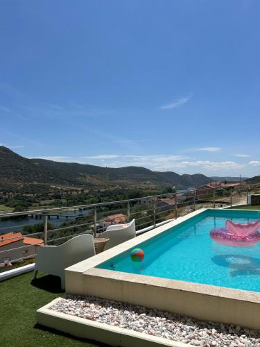 a swimming pool on top of a building at Coração d'Ouro in Torre de Moncorvo
